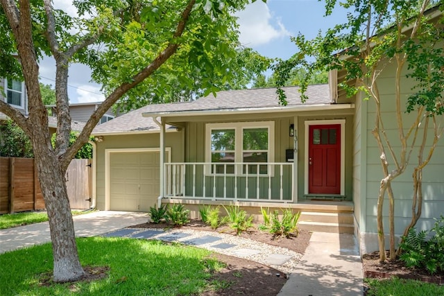 1316 Arcadia Ave, Austin, TX 78757 - view of front of house with driveway, a shingled roof, a garage, and covered porch