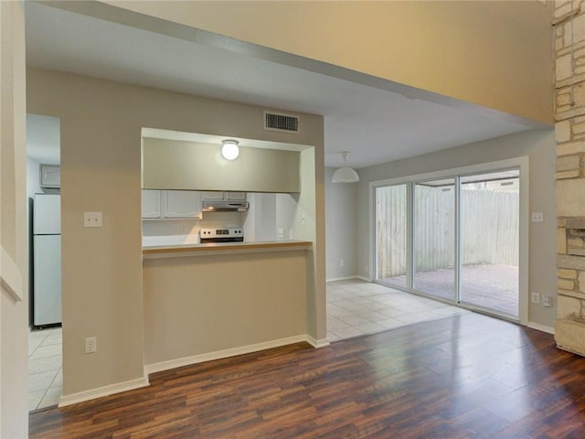 1710 Cinnamon Path, Austin, TX 78704 - unfurnished living room featuring wood finished floors and baseboards