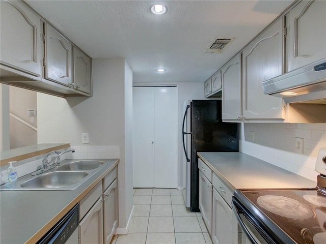1710 Cinnamon Path, Austin, TX 78704 - kitchen with black range with electric stovetop, a sink, dishwasher, tasteful backsplash, and light tile patterned flooring