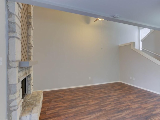 1710 Cinnamon Path, Austin, TX 78704 - below grade area with wood finished floors, a ceiling fan, and a stone fireplace