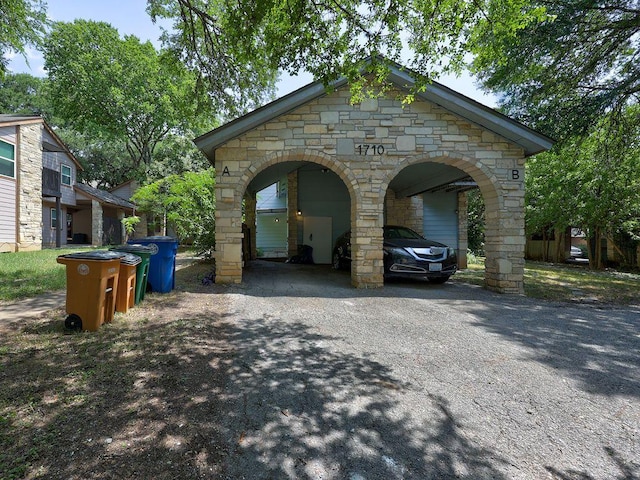 1710 Cinnamon Path, Austin, TX 78704 - view of home's exterior featuring stone siding and asphalt driveway