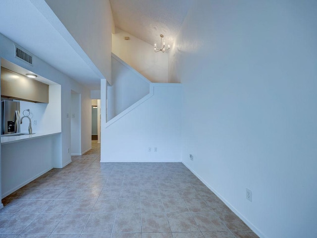 1710 Cinnamon Path, Austin, TX 78704 - unfurnished living room featuring a chandelier and baseboards