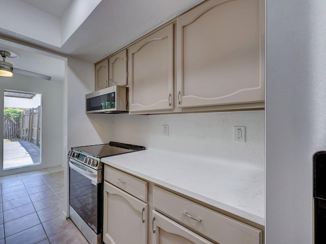 1710 Cinnamon Path, Austin, TX 78704 - kitchen featuring stainless steel appliances and light tile patterned flooring