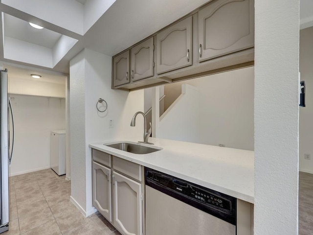 1710 Cinnamon Path, Austin, TX 78704 - kitchen featuring dishwasher, separate washer and dryer, light countertops, light tile patterned flooring, and gray cabinets