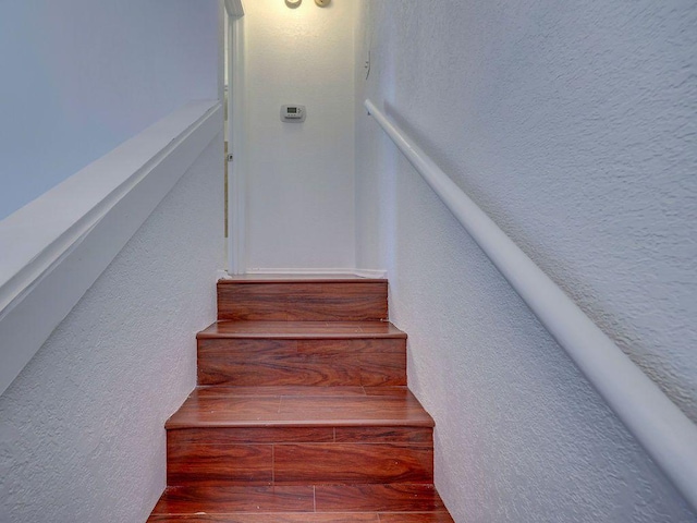 1710 Cinnamon Path, Austin, TX 78704 - stairway featuring a textured wall and wood finished floors