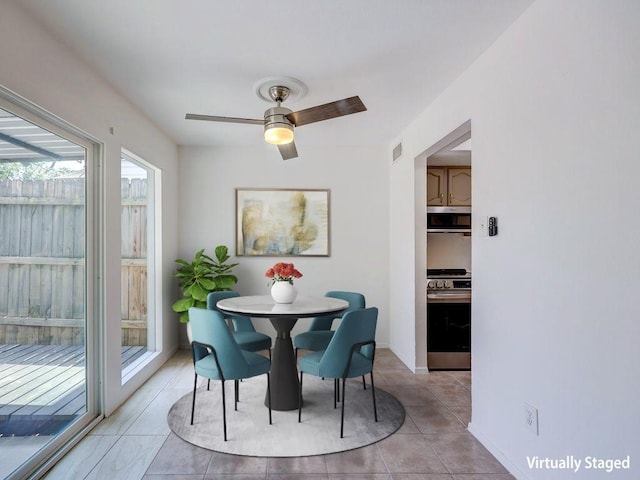 1710 Cinnamon Path, Austin, TX 78704 - dining room with ceiling fan, light tile patterned floors, and baseboards