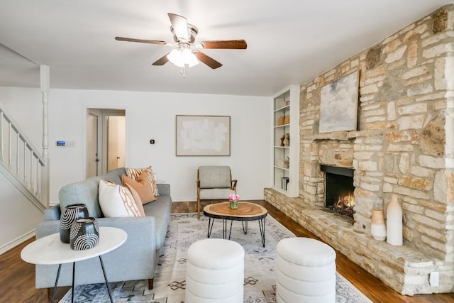 10300 Parkfield Dr, Austin, TX 78758 - living area with built in shelves, ceiling fan, wood finished floors, stairs, and a fireplace