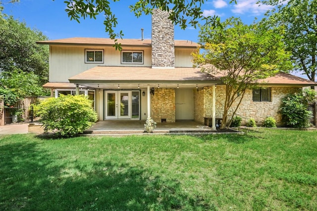10300 Parkfield Dr, Austin, TX 78758 - rear view of house with french doors, a chimney, and stone siding