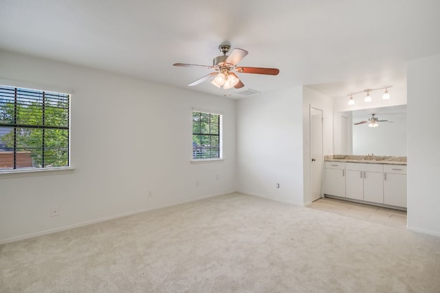 10300 Parkfield Dr, Austin, TX 78758 - spare room featuring light carpet and ceiling fan