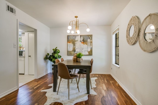 10300 Parkfield Dr, Austin, TX 78758 - dining space featuring wood finished floors and a chandelier
