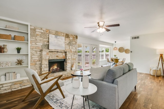 10300 Parkfield Dr, Austin, TX 78758 - living room with a ceiling fan, wood finished floors, and a fireplace