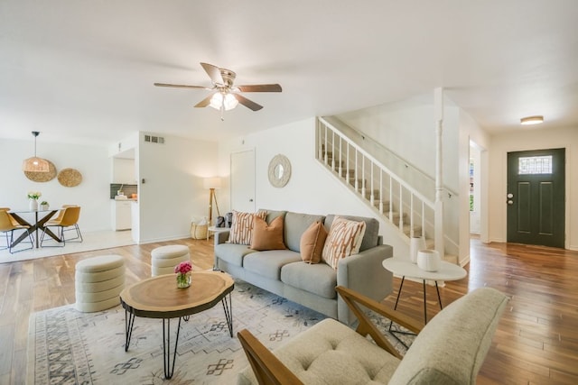 10300 Parkfield Dr, Austin, TX 78758 - living room featuring stairway, wood finished floors, and a ceiling fan