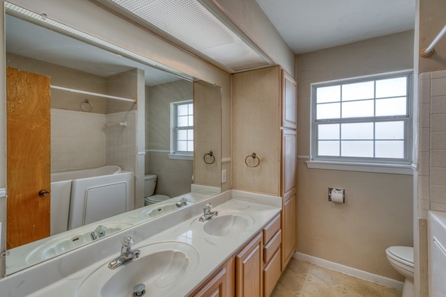 111 Dove Rd, Highland Haven, TX 78654 - full bathroom featuring toilet, double vanity, tile patterned flooring, and shower / washtub combination