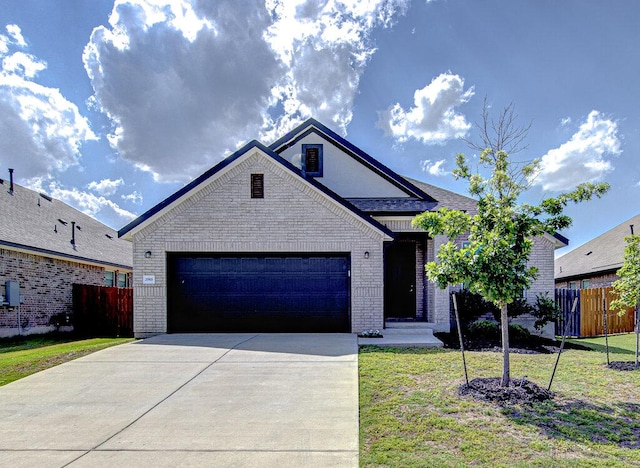 20908 Akbash Ln, Pflugerville, TX 78660 - view of front facade featuring brick siding, a garage, and driveway