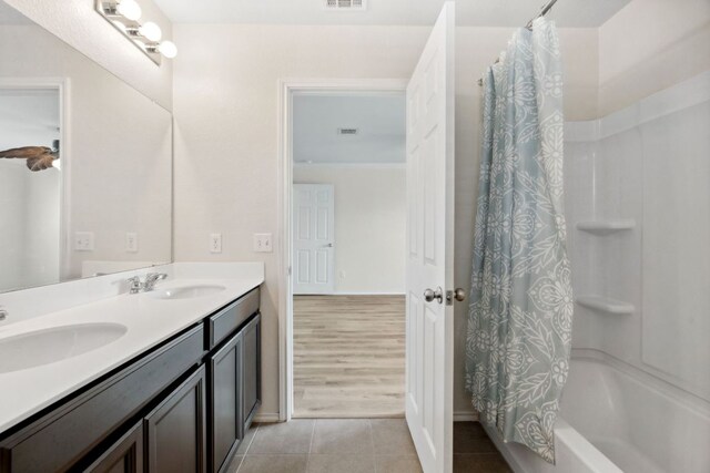 4608 Cleto St, Austin, TX 78725 - bathroom featuring double vanity, shower / tub combo, tile patterned floors, and baseboards