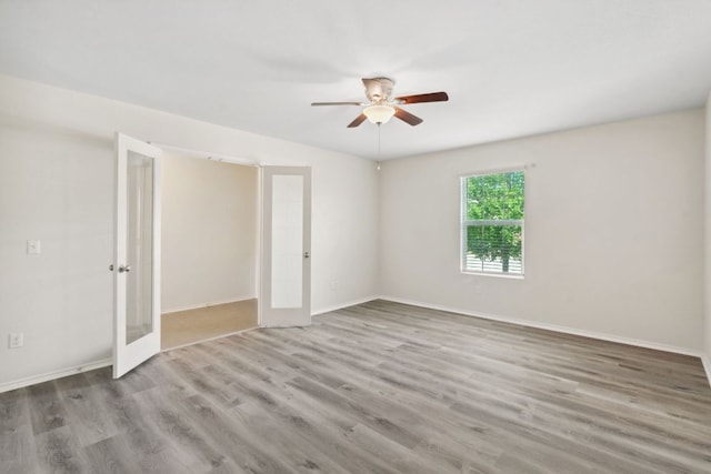 4608 Cleto St, Austin, TX 78725 - empty room featuring french doors, a ceiling fan, wood finished floors, and baseboards
