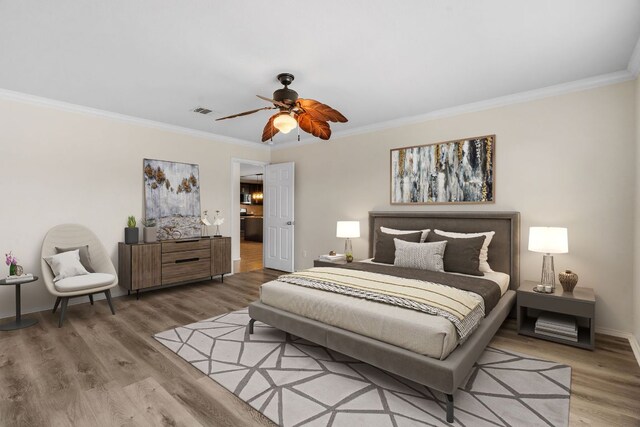 4608 Cleto St, Austin, TX 78725 - bedroom featuring ornamental molding, wood finished floors, baseboards, and ceiling fan