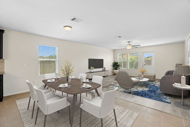 4608 Cleto St, Austin, TX 78725 - dining room featuring light tile patterned floors, healthy amount of natural light, ceiling fan, and baseboards