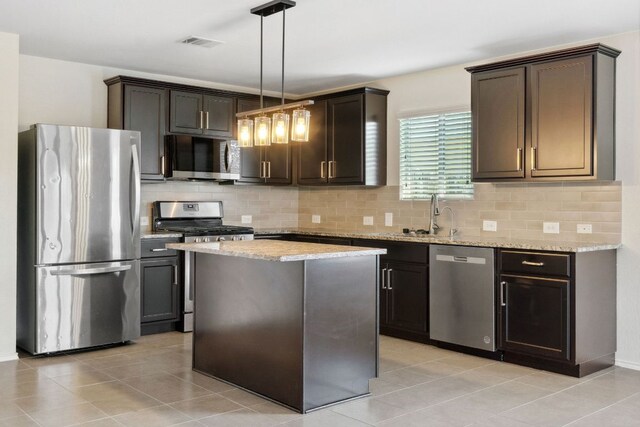 4608 Cleto St, Austin, TX 78725 - kitchen with stainless steel appliances, a sink, tasteful backsplash, and light stone counters