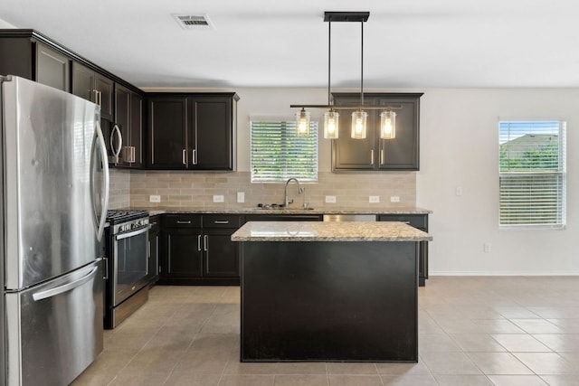 4608 Cleto St, Austin, TX 78725 - kitchen featuring appliances with stainless steel finishes, a sink, decorative backsplash, and light tile patterned flooring