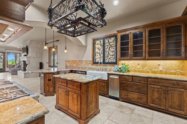 507 Sandy Mountain Dr, Sunrise Beach, TX 78643 - kitchen with decorative backsplash, light stone countertops, a sink, glass insert cabinets, and a peninsula