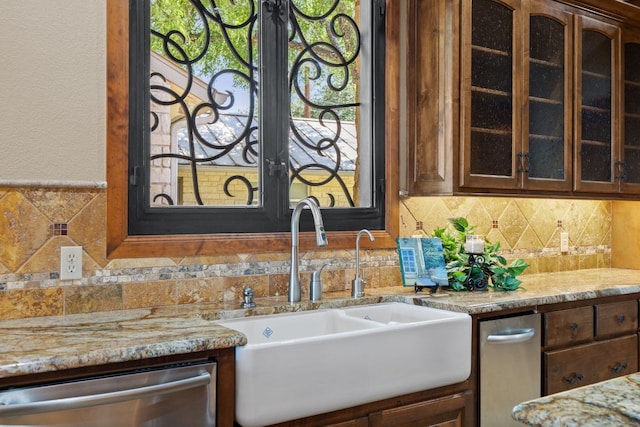 507 Sandy Mountain Dr, Sunrise Beach, TX 78643 - kitchen with dishwasher, a sink, glass insert cabinets, light stone countertops, and backsplash