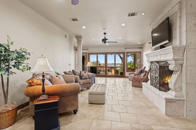 507 Sandy Mountain Dr, Sunrise Beach, TX 78643 - living area featuring ceiling fan, recessed lighting, ornate columns, a high end fireplace, and stone tile flooring