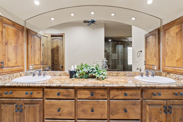 507 Sandy Mountain Dr, Sunrise Beach, TX 78643 - full bath with double vanity, a shower stall, ceiling fan, and recessed lighting