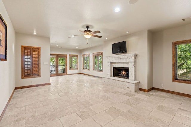 507 Sandy Mountain Dr, Sunrise Beach, TX 78643 - unfurnished living room with baseboards, a high end fireplace, a ceiling fan, and recessed lighting
