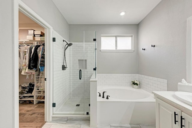 2407 Powderham Ln S, Cedar Park, TX 78613 - full bathroom with a garden tub, a shower stall, a spacious closet, and vanity