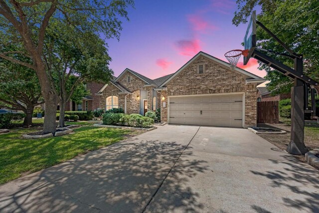 2407 Powderham Ln S, Cedar Park, TX 78613 - view of front of property with concrete driveway, a lawn, a garage, and brick siding