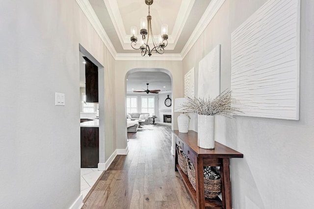 2407 Powderham Ln S, Cedar Park, TX 78613 - hall with ornamental molding, arched walkways, wood finished floors, and a chandelier