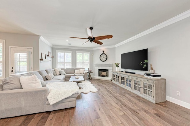 2407 Powderham Ln S, Cedar Park, TX 78613 - living area featuring crown molding, a ceiling fan, a brick fireplace, wood finished floors, and baseboards