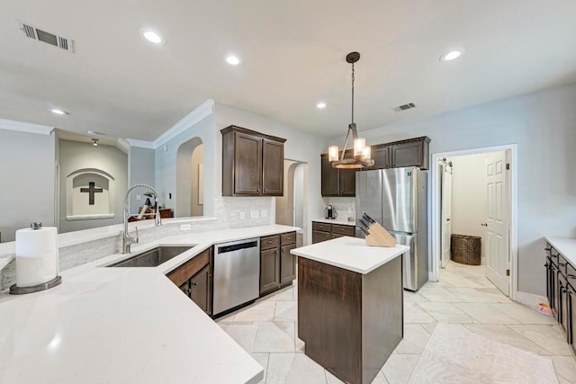 2407 Powderham Ln S, Cedar Park, TX 78613 - kitchen featuring appliances with stainless steel finishes, a sink, arched walkways, a chandelier, and dark brown cabinets
