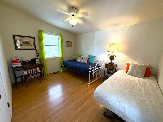 315 Skyline Dr, Sunrise Beach, TX 78643 - bedroom with light wood-style floors, vaulted ceiling, and a ceiling fan