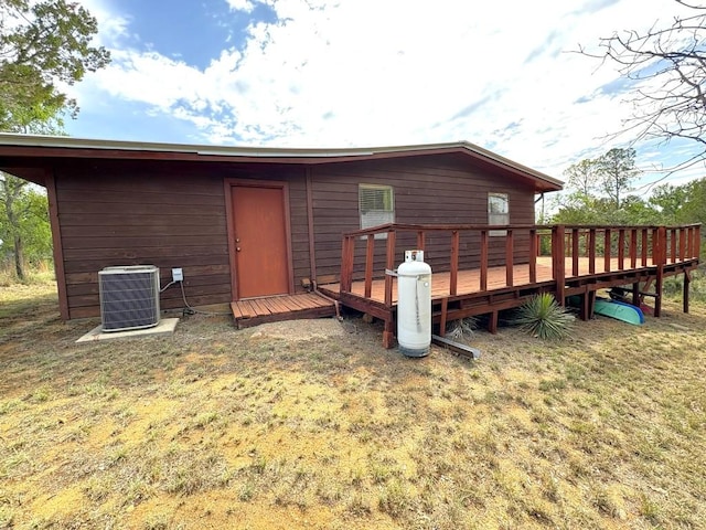 315 Skyline Dr, Sunrise Beach, TX 78643 - back of house with central AC unit, a deck, and a lawn
