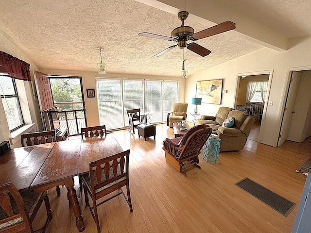 315 Skyline Dr, Sunrise Beach, TX 78643 - dining room with a textured ceiling, light wood-style floors, vaulted ceiling, and a ceiling fan