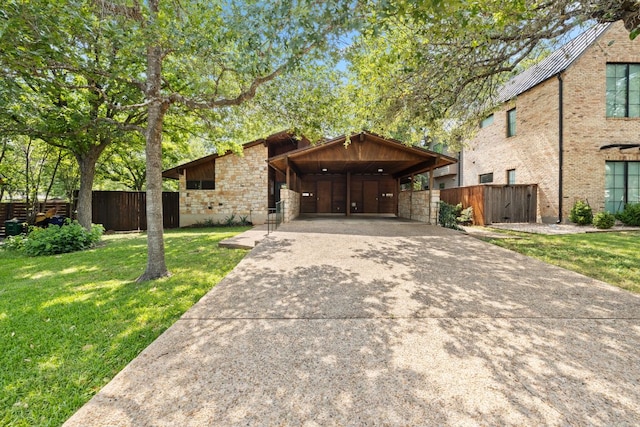 2309 Westoak Dr, Austin, TX 78704 - mid-century modern home with driveway, stone siding, and an attached carport