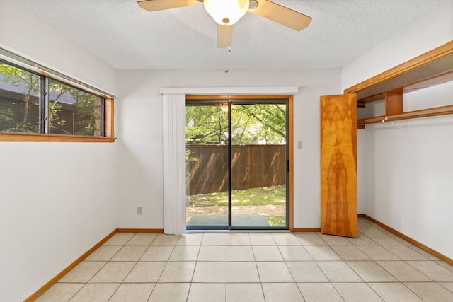 2309 Westoak Dr, Austin, TX 78704 - unfurnished bedroom with access to exterior, a textured ceiling, a closet, a ceiling fan, and baseboards