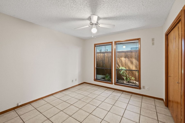 2309 Westoak Dr, Austin, TX 78704 - unfurnished bedroom with a textured ceiling, baseboards, and a ceiling fan