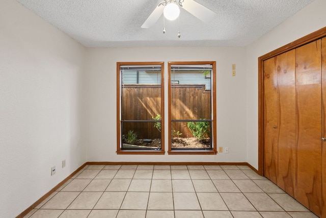 2309 Westoak Dr, Austin, TX 78704 - unfurnished bedroom with a textured ceiling, baseboards, a ceiling fan, and a closet