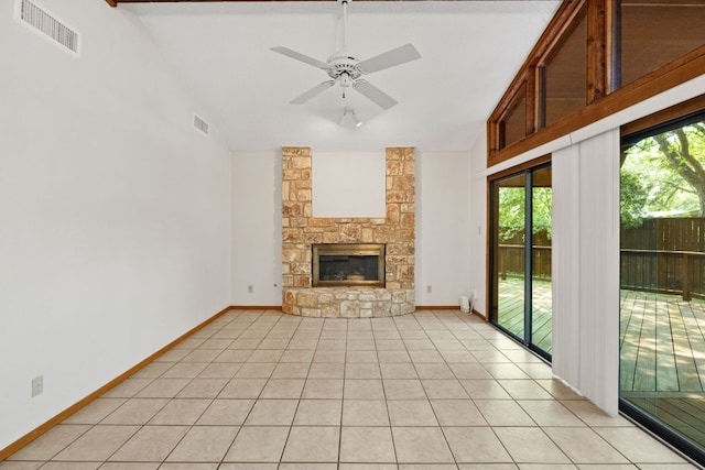 2309 Westoak Dr, Austin, TX 78704 - unfurnished living room with lofted ceiling, ceiling fan, a stone fireplace, light tile patterned floors, and baseboards
