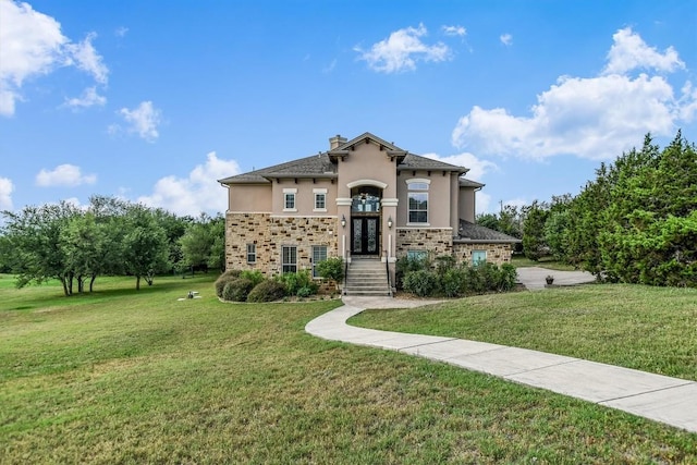 9501 Derecho Bnd, Austin, TX 78737 - view of front of property with stucco siding, french doors, a front yard, a chimney, and stone siding