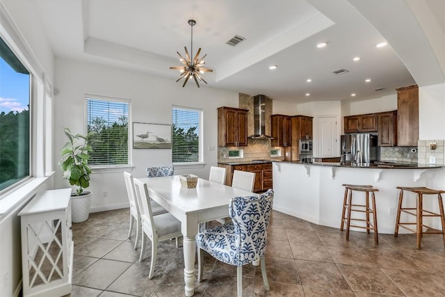 9501 Derecho Bnd, Austin, TX 78737 - dining room with a tray ceiling, tile patterned flooring, recessed lighting, and a chandelier