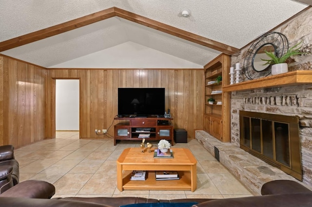 300 W Sequoia Spur, Georgetown, TX 78628 - living area featuring a textured ceiling, wood walls, built in shelves, light tile patterned floors, and a large fireplace