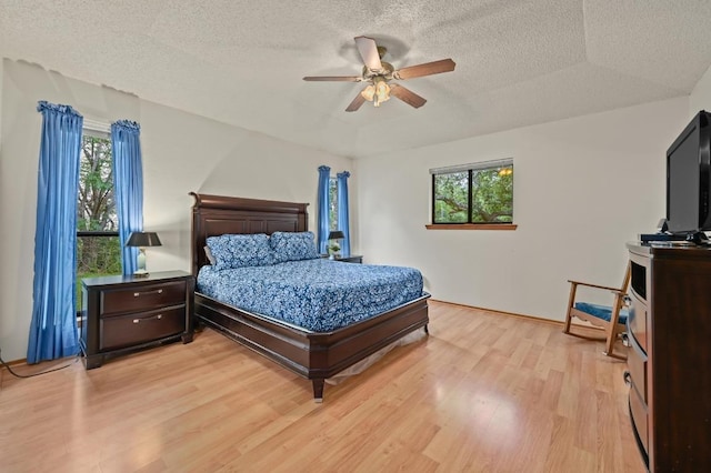300 W Sequoia Spur, Georgetown, TX 78628 - bedroom with light wood-type flooring, a textured ceiling, a ceiling fan, and baseboards