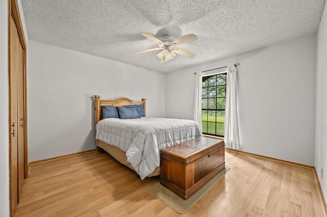 300 W Sequoia Spur, Georgetown, TX 78628 - bedroom featuring light wood finished floors, a textured ceiling, a ceiling fan, and baseboards
