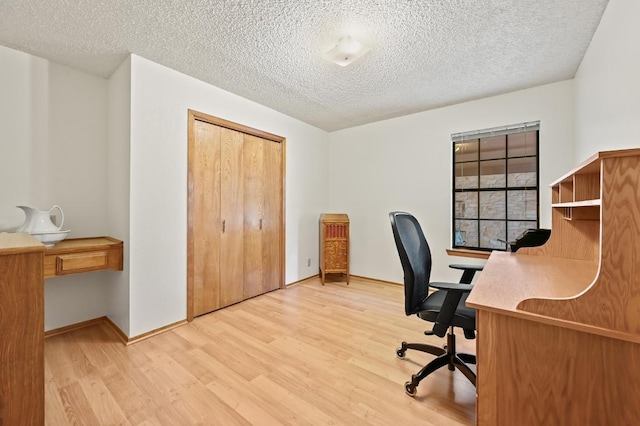300 W Sequoia Spur, Georgetown, TX 78628 - office space featuring light wood finished floors, a textured ceiling, and baseboards