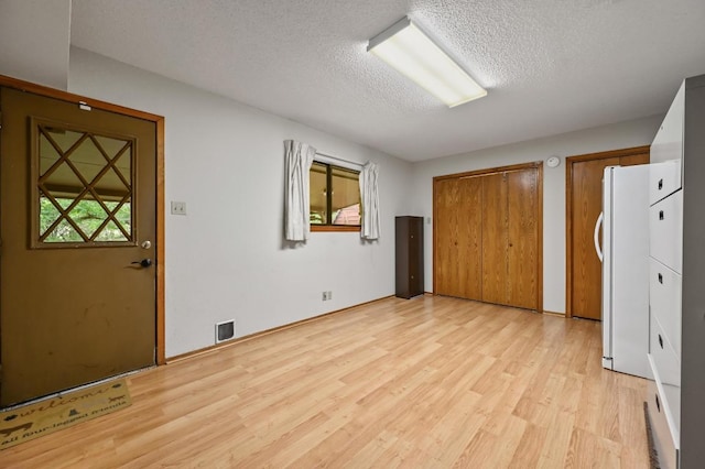 300 W Sequoia Spur, Georgetown, TX 78628 - entryway featuring light wood-style flooring, healthy amount of natural light, and a textured ceiling