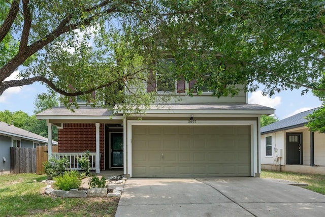 11607 Robert Wooding Dr, Austin, TX 78748 - view of front of property with concrete driveway, covered porch, an attached garage, and brick siding